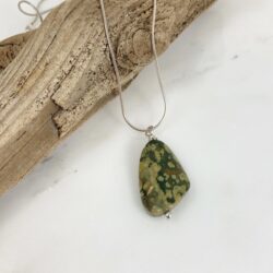 Asymetrical rhyolite pendant with shades of dark green, olive green, and deep brown on a sterling chain.