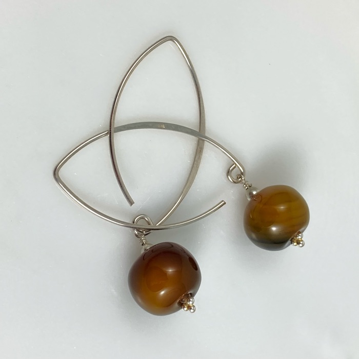 Yellow agate puff donut earrings on arch-shaped sterling ear hooks.